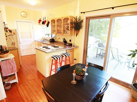 Across dining area toward kitchen with half bath in back