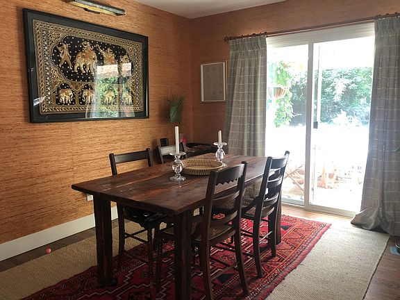Dining area with access to porch and patios. Dining chair and tables can be included.