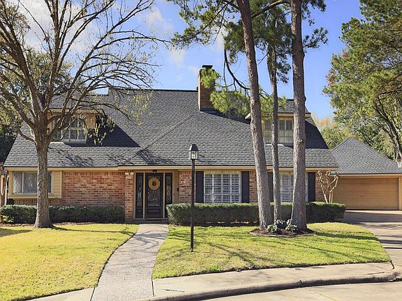 Additional view of home which shows the great curb appeal and beautiful mature trees.