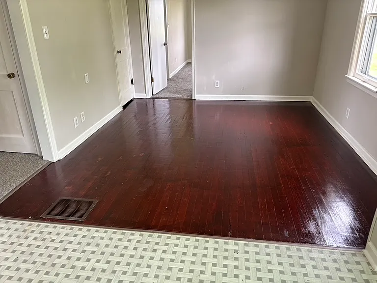 Breakfast nook is vinyl floor, dining room is hardwood floor