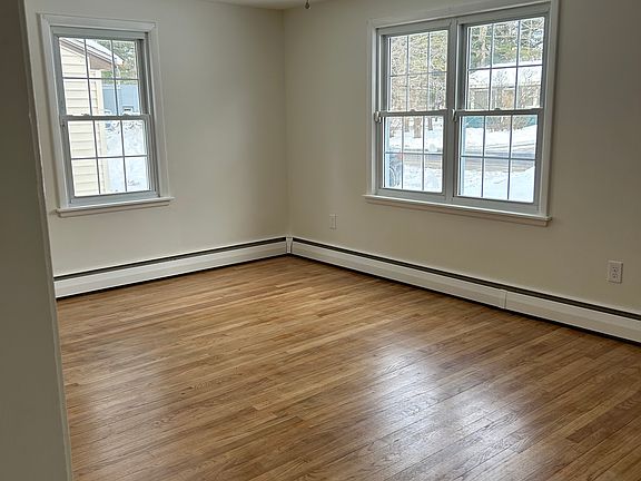 Beautiful hardwood floors in living spaces complemented by newly painted walls.