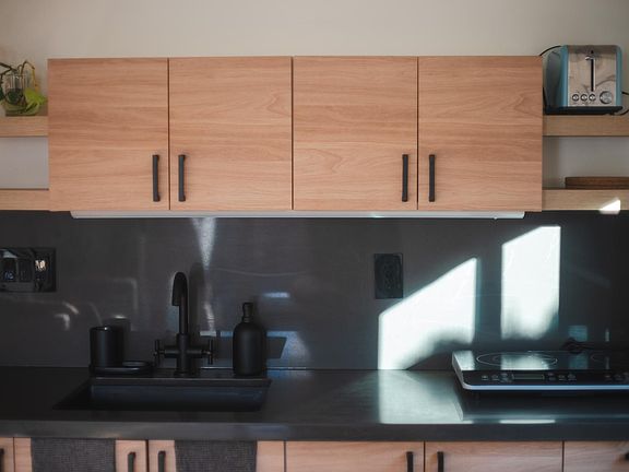 Kitchenette with 2-burner induction cooktop, combo microwave/convection/airfryer, blender, toaster, French press, and all the basics.