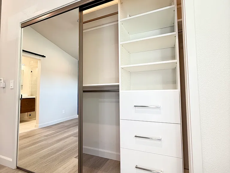 Main bedroom suite with large closet with built in cabinet organizer.