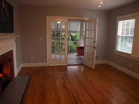 French Doors in Light-Filled Living Room open onto Screened