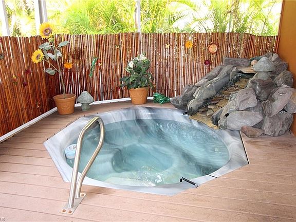 In ground hot tub with lighted waterfall