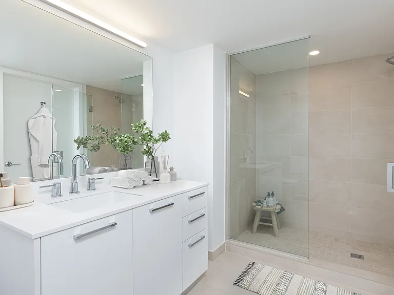 Large vanities and spacious walk-in showers are yours.