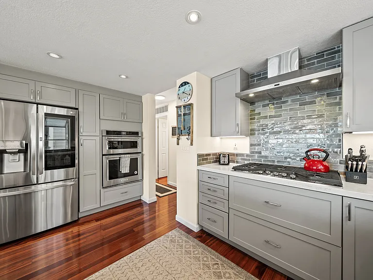 kitchen view with smart microwave, oven, convection oven, and fridge