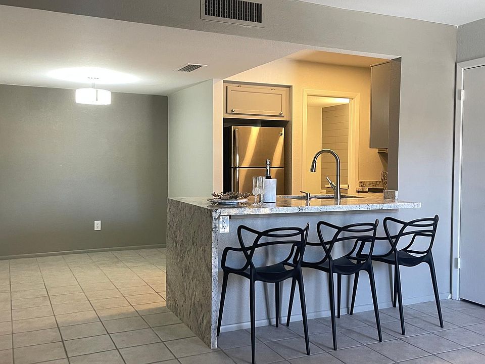Kitchen with waterfall effect countertop, closet on the right side, dining area on the left side. Room for a square, round or rectangular table.