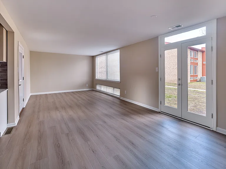 Spacious 2 Bed, 1.5 Bath with 989 sq. ft., large windows, and beautiful wood-style flooring.