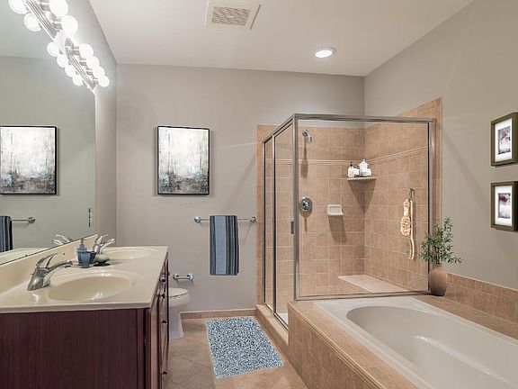 Primary Bath Features Dual-sink Vanity, Soaker Tub, and Large Shower