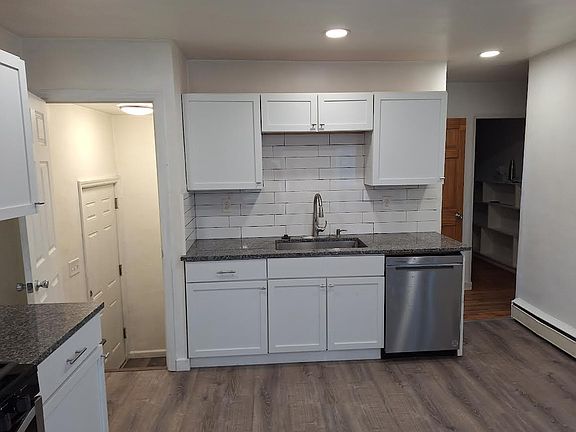 Touchless water faucet on farmer style sink with garbage disposal