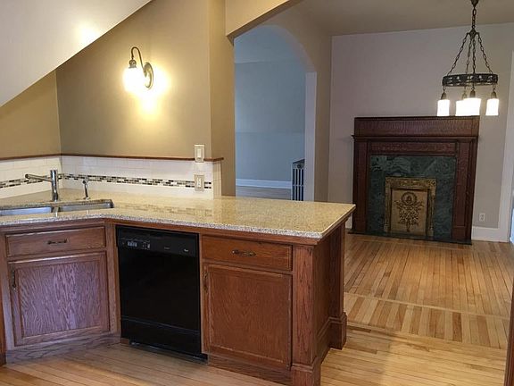 Kitchen open to dinning room. Granite countertops. Oak cabinets. Large wall of pantry cabinets to the right. (Not in picture.)