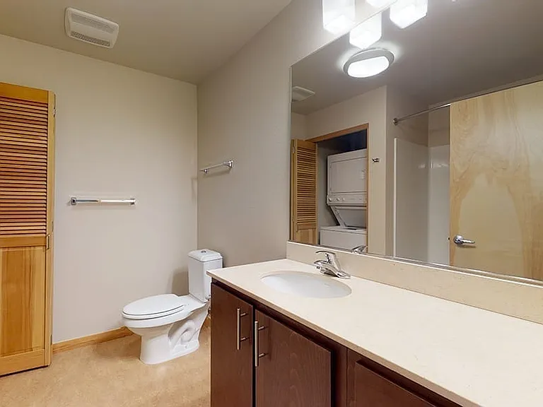 Apartment bathroom with tile flooring.
