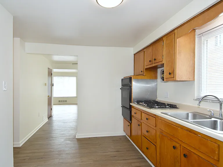 Spacious kitchen with access to dining & living room beyond.