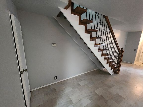 view from living room to stairs and front door