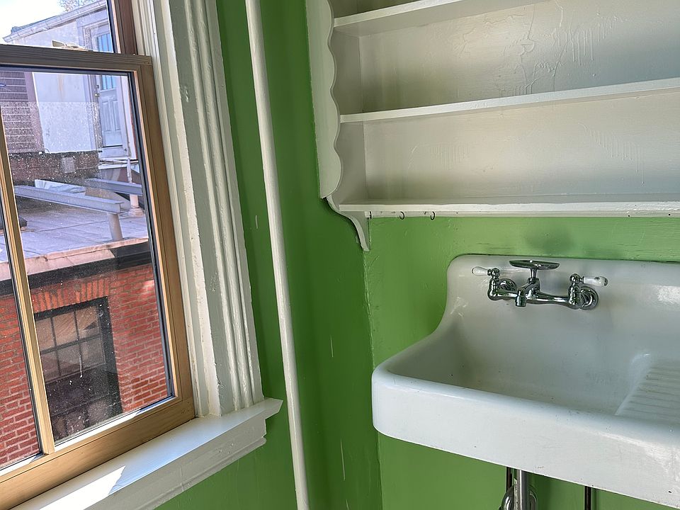 The kitchen includes vintage enamel covered cast iron sink.