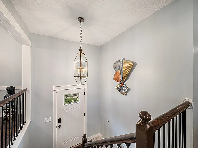 Step into a bright, welcoming foyer with convenient access to both the basement and main living areas_an inviting and practical introduction to the home.