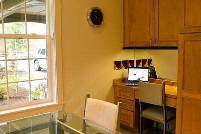 Kitchen has a built in desk area. 