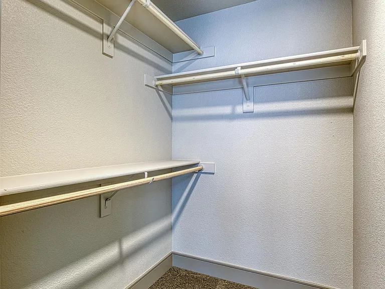 Expansive closet with open shelving and ample room for organized storage.