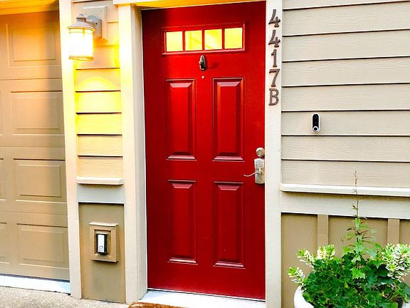 Front door equipped with code keypad and Nest doorbell.