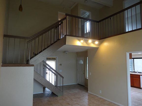 living room has vaulted ceiling; foyer