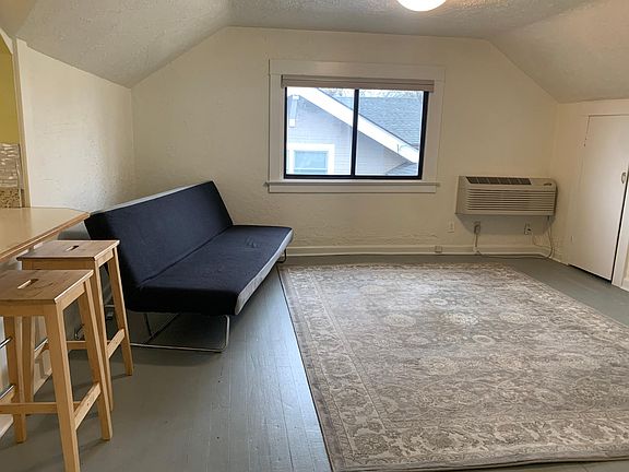 Living room; rug and stools included but futon is not.