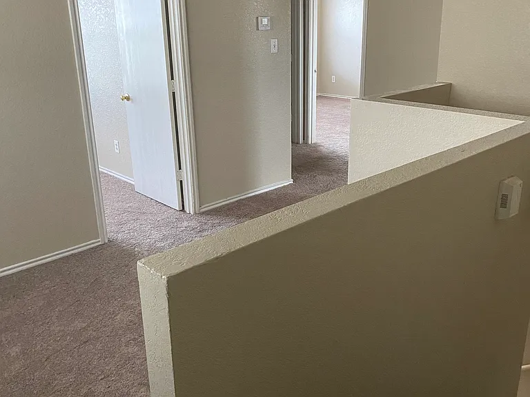 Top of stairs leading to a loft area showing 2 Bedrooms and Bathroom