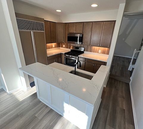 First floor brand new kitchen with all new appliances: Subzero refrigerator, stove, microwave, and dishwasher