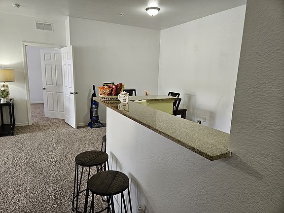 Stylish kitchen bar with a sleek countertop and comfortable seating_perfect for casual dining, entertaining, or enjoying your morning coffee.