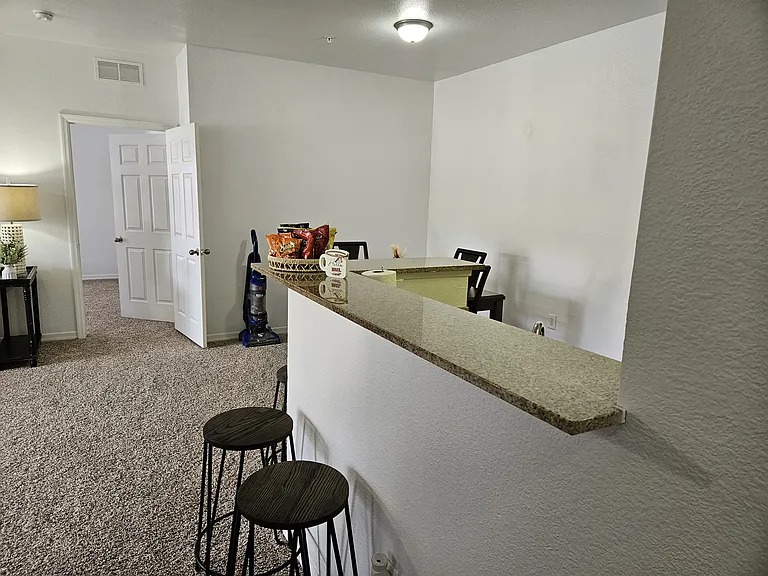 Stylish kitchen bar with a sleek countertop and comfortable seating_perfect for casual dining, entertaining, or enjoying your morning coffee.