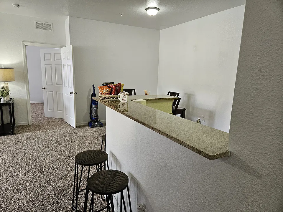Stylish kitchen bar with a sleek countertop and comfortable seating_perfect for casual dining, entertaining, or enjoying your morning coffee.