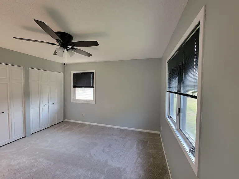 Master bedroom has two windows, great light, aluminum blinds, huge closet, new paint, carpet, ceiling fan.