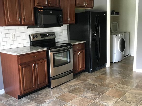 High end kitchen with granite counters and real wood cabinet