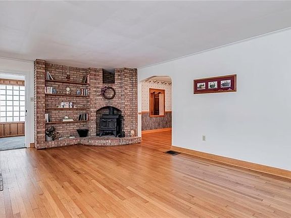 Spacious Living room with Gorgeous Brick Built-in Bookcases and Woodburner