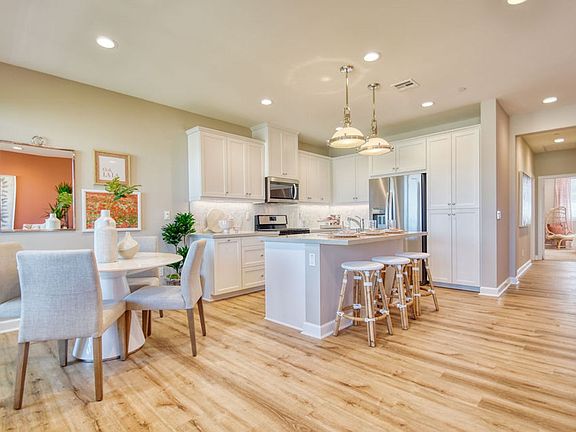 An image of the kitchen and dining space in the Citrus Plan 3 Model Home at New Haven.