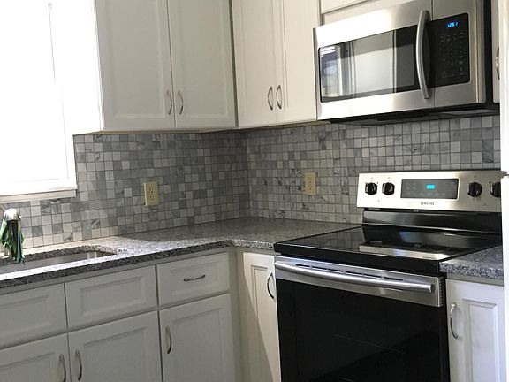 New granite counter tops, new cabinets, new tile backsplash, new built in microwave, new electric range, new large sink and spigot, new vinyl plank flooring