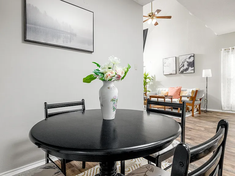 Cozy dining area with a round table for 4, plus additional seating for 2 at the kitchen island_perfect for meals, coffee, or conversation.