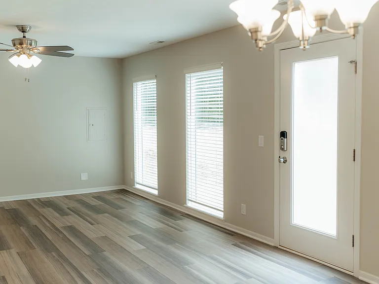 Living/dining with door to exterior. This door has privacy film, so no blinds or curtains needed. Allows sunshine in and maintains privacy.
