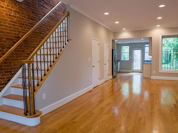Open living and dining area with staircase leading to the second floor