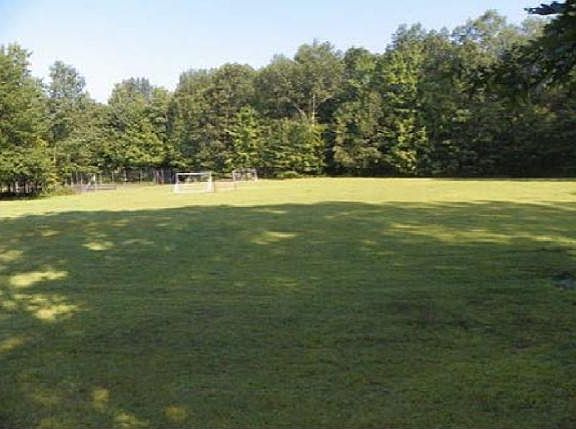 Large community open space with playground, includes opportunity to have a garden plot