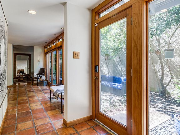 TONS of natural light in this entry with floor to ceiling and wall to wall windows and sliding glass doors.