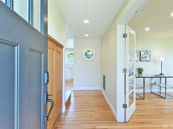 Welcome home! Refinished oak hardwoods and glass french doors to living room.