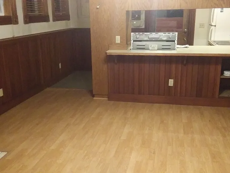 Living Room Looking at Kitchen Counter and Large Opening Windows on South Side of Building -- Lots of Light!