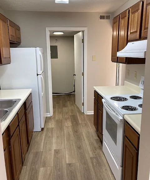 kitchen in foreground, mechanical room in background (also has washer/dryer hookup in mechanical room)