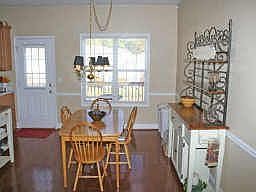 DINING AREA HAS HARDWOOD FLOORS AND DROP CHANDELIER. DOUBLE WINDOWS ADD LIGHT.