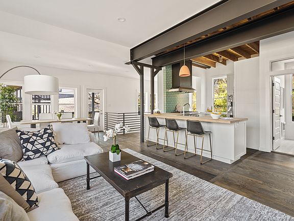 Rich wood floors throughout with high and open ceilings
