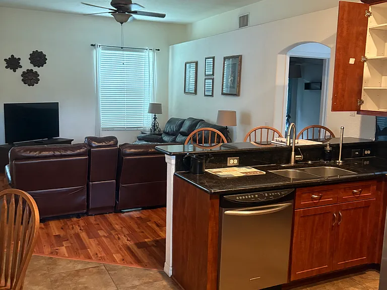 Kitchen view of Entertainment Room with Oversize Sofa Recliner combo and 50' TV