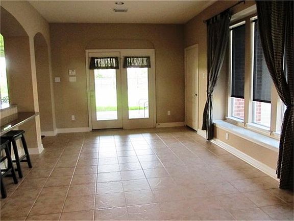 Huge breakfast area looks out onto covered patio. Lots of room