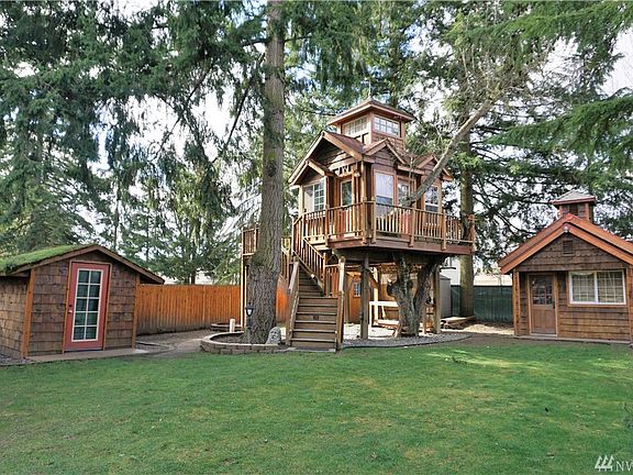 Treehouse w/power, heat, insulation, almost completely finished.  Outbuildings/storage sheds (4)!