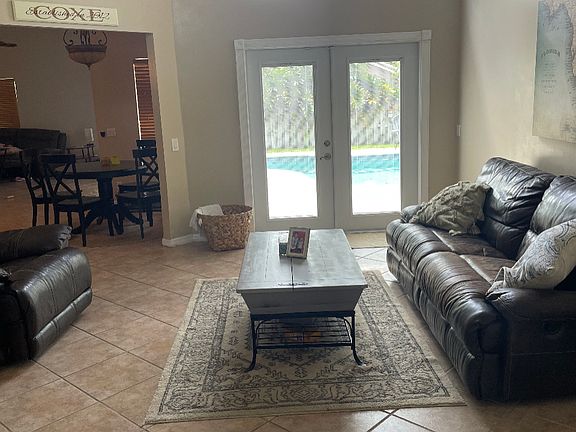 enter foyer to high ceiling living room with french doors that lead private pool and backyard area ample space for playground, garden or dogs